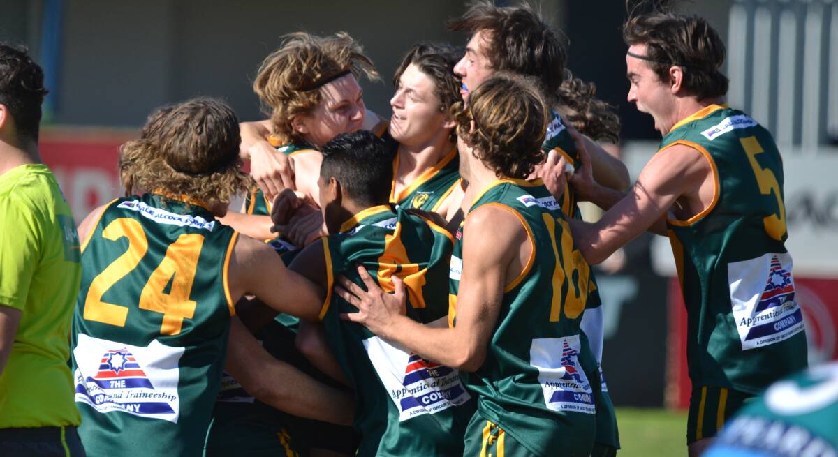Jubilation: The South West Football League colts side rush to embrace Sebastian Dixon who kicked the match winner after the final siren on Saturday. Photo: Justin Rake. 