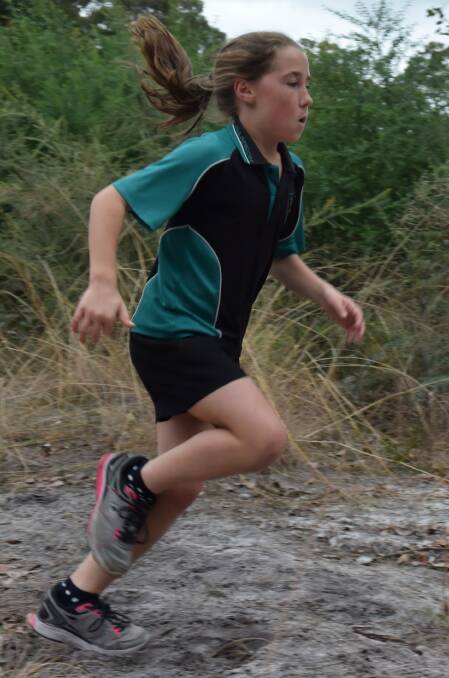 Kaitlin Davies sprinted through Allanson Primary School's cross country track, facing terrain such as the oval, red dirt roads, and bushland before reaching the finish line. 