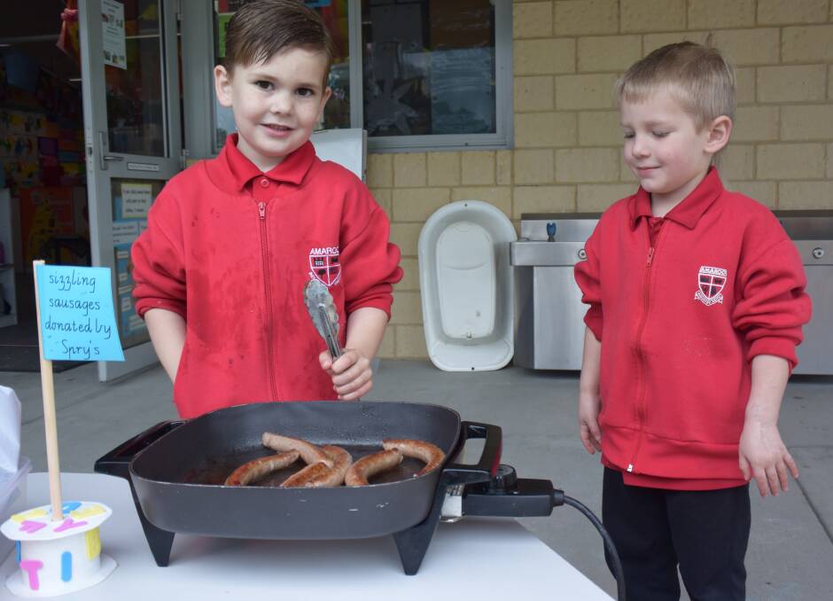 Cooking frenzy at Amaroo: Quade Bucktin and Kayden Dunster cooked sizzling sausages on the barbecue for their class mates. 