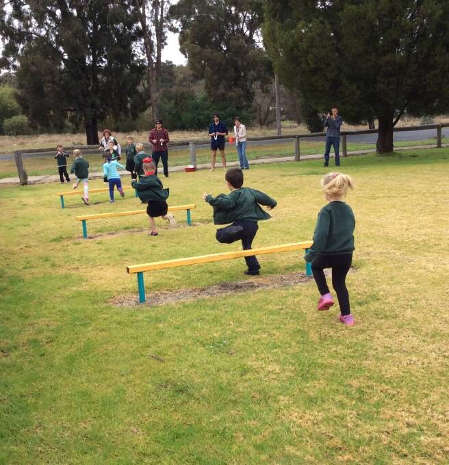 Jumping across the oval: The students at Allanson Primary School participating in a range of Olympic sports including the hurdles. 