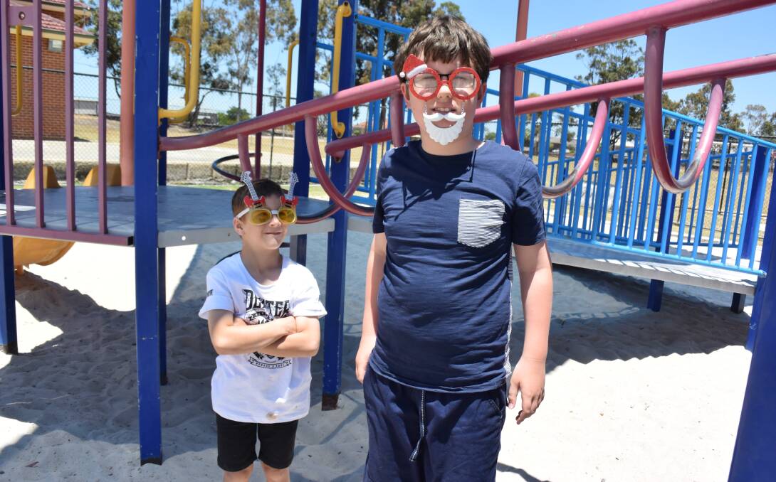 In the playground: Zac and Thomas showed off their free-dress outfits and wacky sunglasses during their fundraising day. 