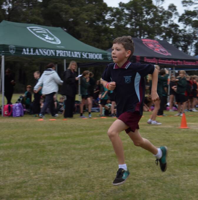 Joshua Lankford raced to the finish line as his Wilson Park Primary School classmates cheered him on during the cross country carnival. 