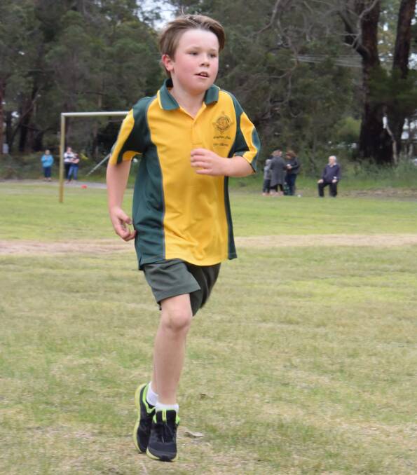 Bryce Wood sped down the home straight in the interschool cross country event, with students, teachers and parents watching on.