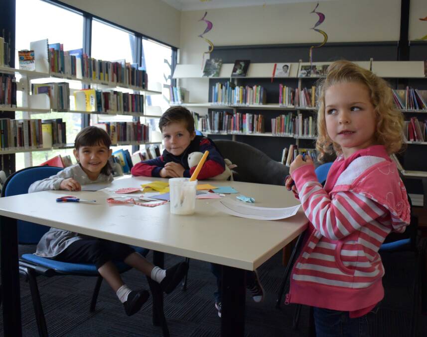 Library activities: Blake, Ruby and Taylor participated in arts and crafts activities during the Teddy bear's picnic event last Friday.