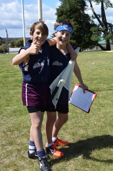 Working hard: Brodie Becker and Jacobe Barnes took turns as goal umpire and score keeper throughout Amaroo Primary School's football event, part of the Survivor program.