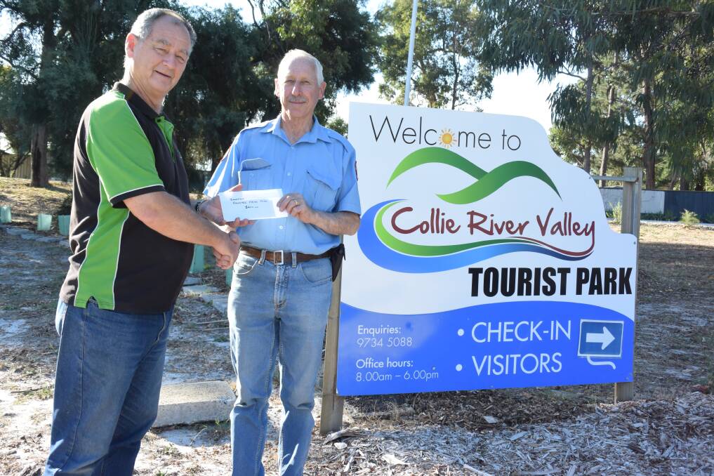 Donation: Collie River Valley Tourist Park Manager Patrick Honeywill hands the $400 donation to Chief Bush Fire Control Officer Terry Hunter. Photo: Thomas Munday. 