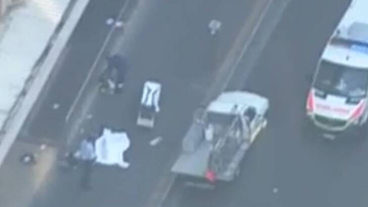 Paramedics at the scene of the Parramatta shooting attending to one of the two bodies. Photo: Seven News