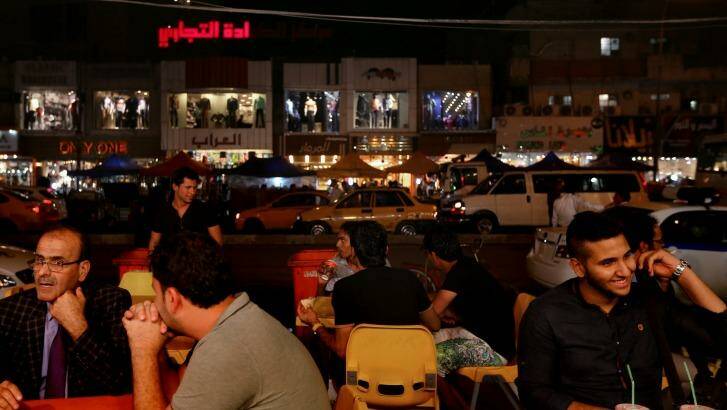 Normal life: Iraqis at a restaurant in the Karada district of the capital.  Photo: Kate Geraghty