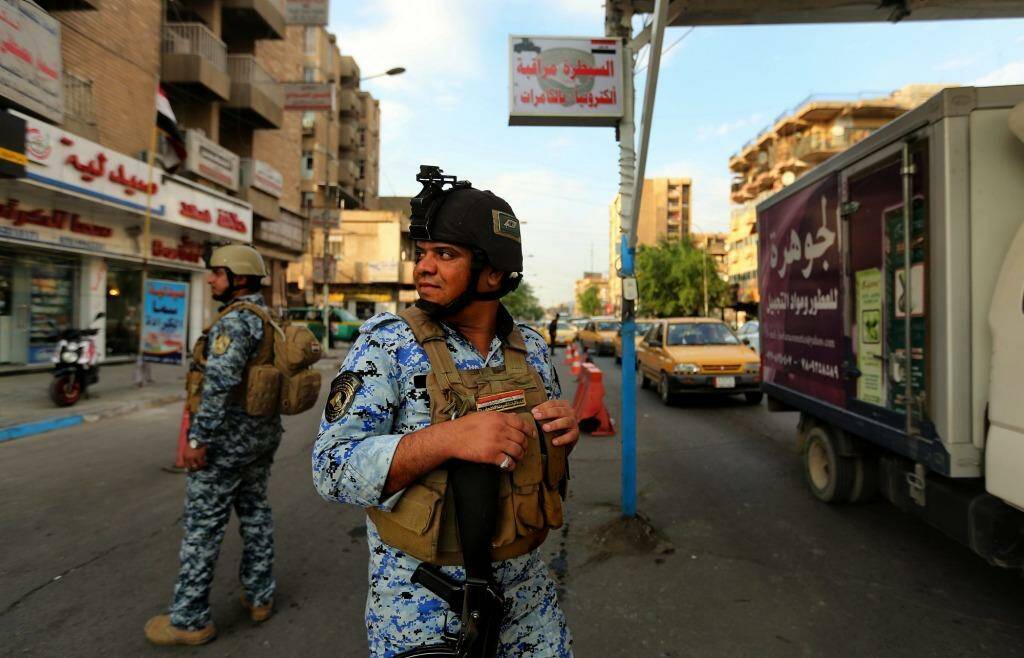 Nervous state: on a day when six bombs went off in the city, Iraqi policemen patrol Baghdad's Karrada district.  Photo: Kate Geraghty