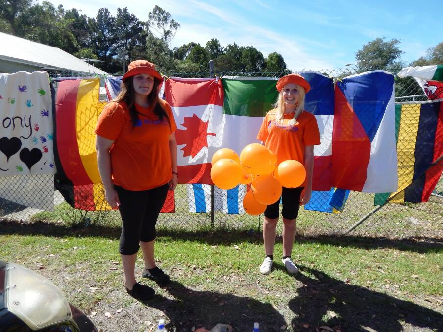 Colourful sight: Shannon Hickman and Caitlyn Bennett in front of the impressive flag display.