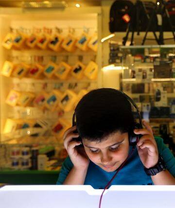 At the shops: two boys listen to music in a store at Baghdad's Mansour Mall. Photo: Kate Geraghty