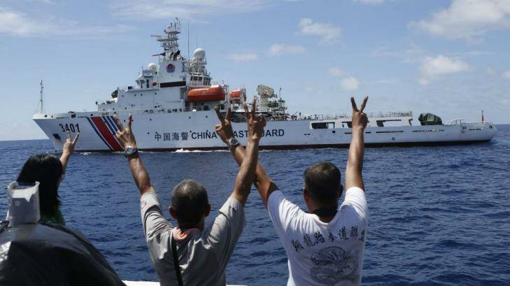 Philippine Marines gesture towards a Chinese Coast Guard vessel, trying to block a Philippine supply ship reaching disputed Spratly Islands, in the South China Sea March 29, 2014.  Photo: Reuters/Erik De Castro