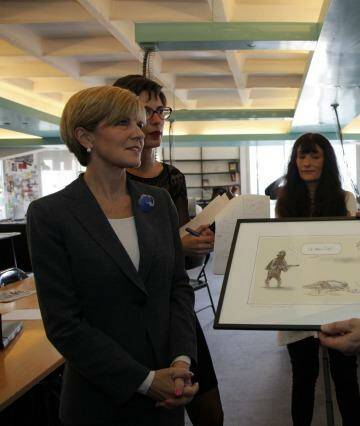 Foreign minister with the famous cartoon at the temporary offices of Charlie Hebdo. Photo: Antoine Gyori