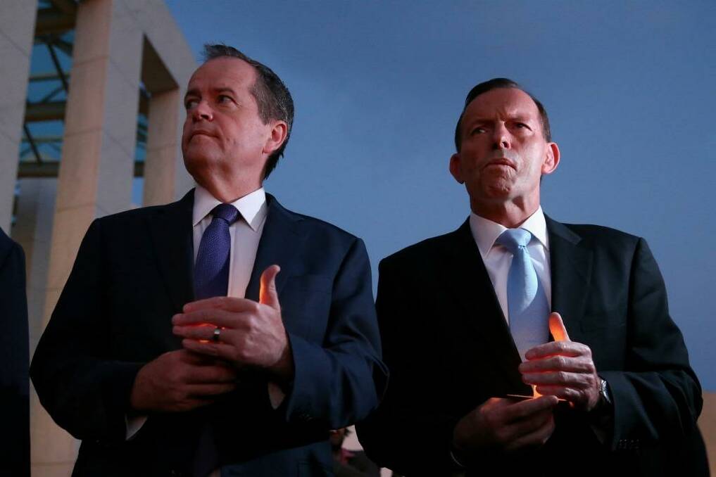 Opposition Leader Bill Shorten and Prime Minister Tony Abbott during a candlelight vigil for Andrew Chan and Myuran Sukumaran at Parliament House on Thursday.  Photo: Alex Ellinghausen