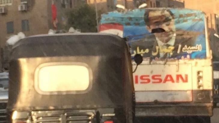 A photo of Gamal Mubarak plastered on the back of truck in Cairo traffic, March 2017. Photo: Farid Farid