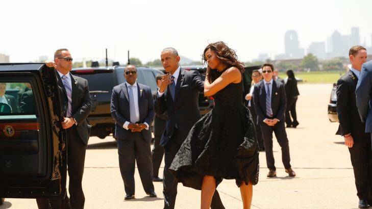 President Barack Obama, right, and first lady Michelle Obama are greeted by local officials as they arrive at service in Dallas. Photo: Tom Fox
