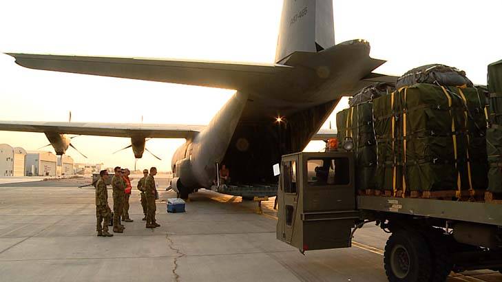 Support: Australian troops load supplies for trapped Iraqis. Photo: Janine Fabre/Australian Defence 