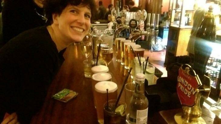 Michelle McGagh with the round of drinks she bought at the end of her no-spend year.  Photo: Twitter: @mmcgagh