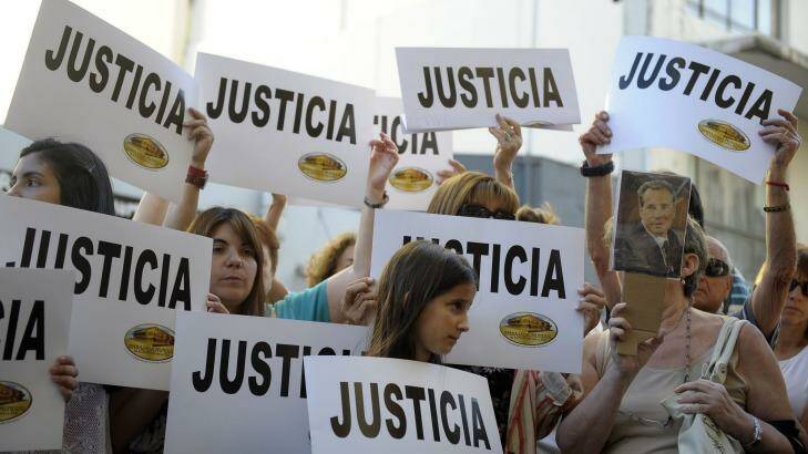 People hold placards that read "Justice"  during a rally in front of the headquarters of the AMIA (Argentine Israelite Mutual Association), in Buenos Aires. Photo: Supplied