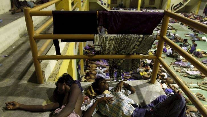 Migrants believed to be Rohingya rest inside a shelter after being rescued by fishermen at Lhoksukon in Indonesia's Aceh Province on Monday. Photo: Roni Bintang