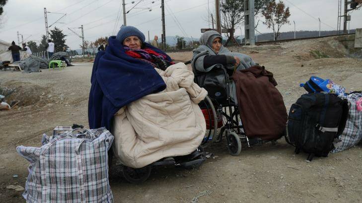 Two women in wheelchairs wait for the border to Macedonia to open. Photo: Nick Miller
