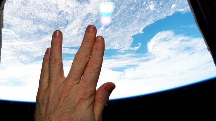 Astronaut Terry Virts gives the Vulcan salute from the cupola of the International Space Station in a tribute to actor Leonard Nimoy. Photo: Terry Virts