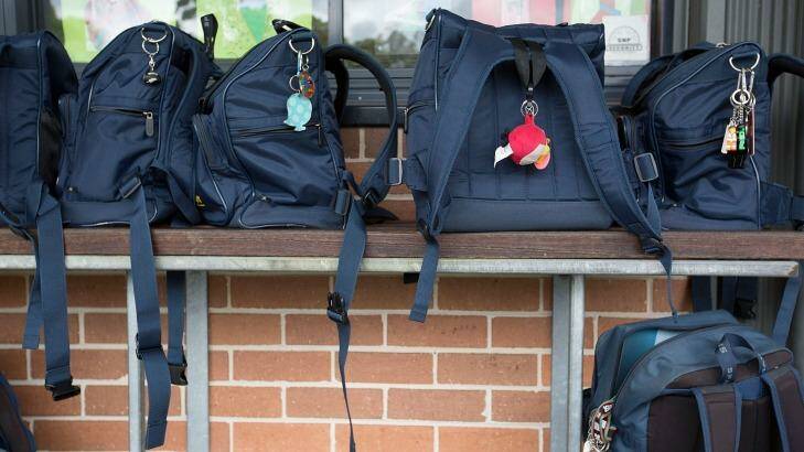 Schoolbags line a wall at a NSW Catholic school.  Photo: Michele Mossop