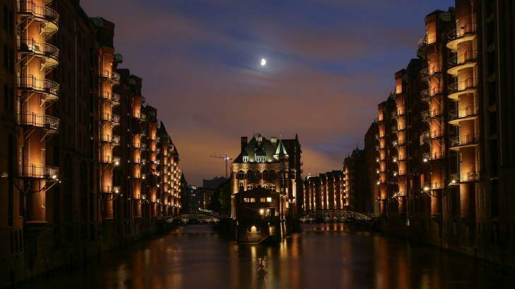 The moon shines over the Old Warehouse District in Hamburg, northern Germany.  Photo: DPA