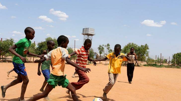Play time: A game of football inside the camp. Photo: Edwina Pickles