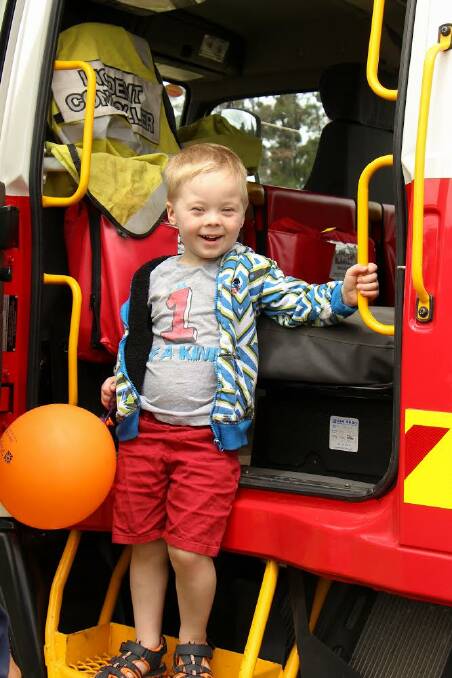 All smiles: Rylan Payze checks out the fire engine.