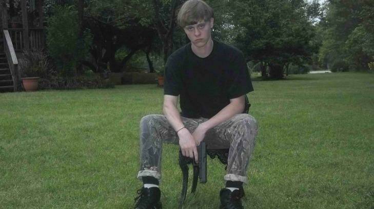 A handout photograph posted to a website with a racist manifesto appears to show Dylann Roof posing with a handgun.  Photo: HANDOUT