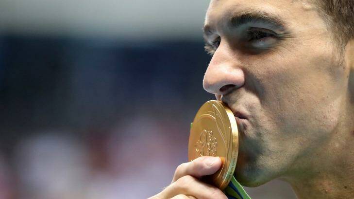 United States' Michael Phelps celebrates with his gold medal after the men's 200m butterfly. Photo: Lee Jin-man