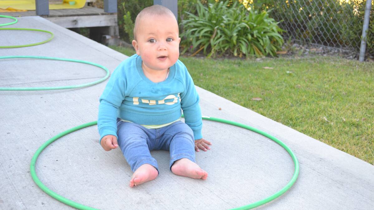 Hooped: Sienna Harker sits on her pretend green lily pad.