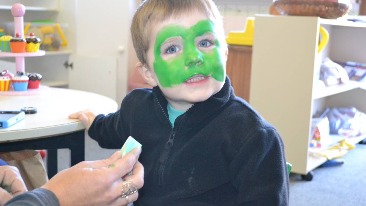 Frog face: Blake Digney sits down for a fresh froggy face paint.