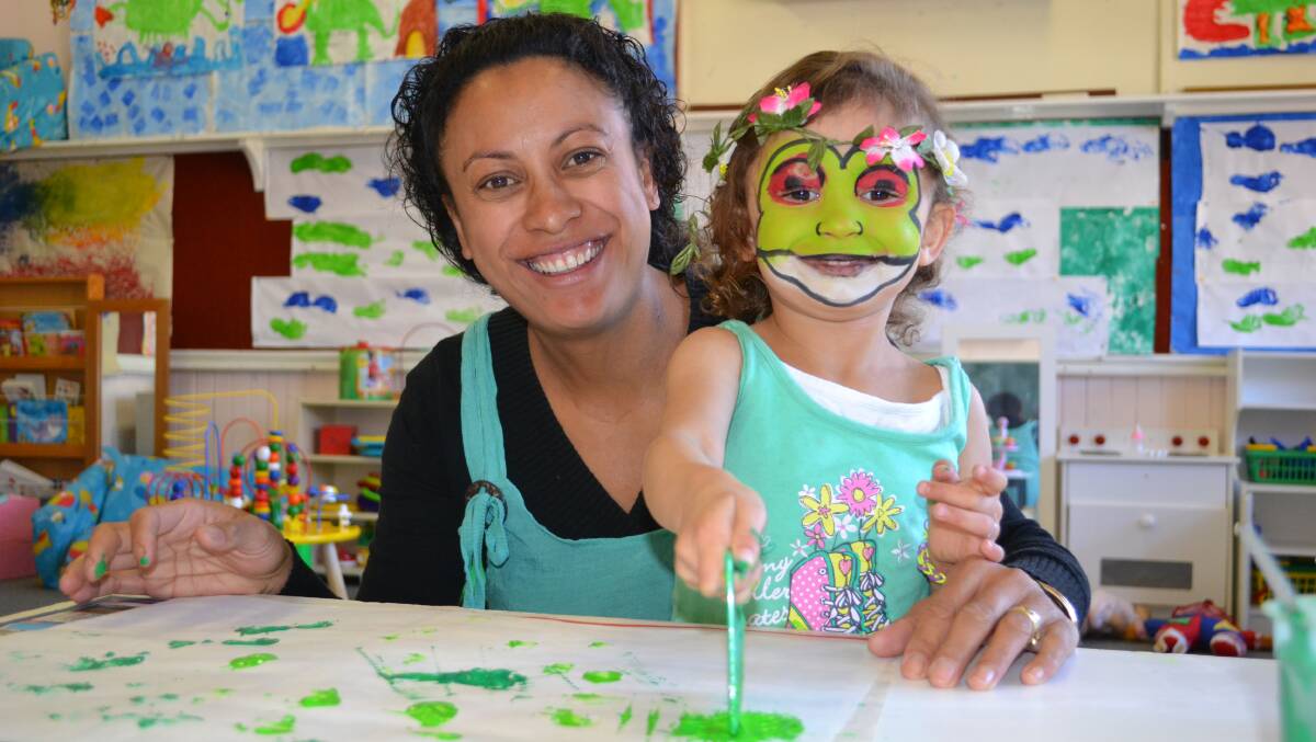 Floral froggy: Katrina and Evie Wilson have some fun painting green frogs.