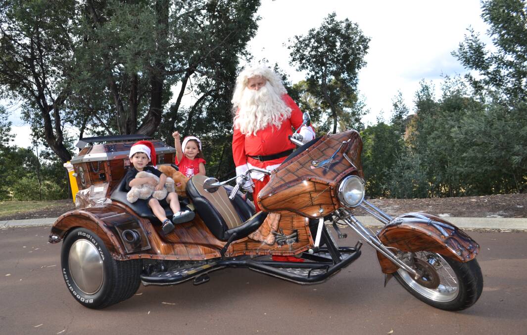 Unconventional sleigh: Santa takes Darius Mandry and Aurora Sopolinksi for a ride. Riders are gearing up for the 19th annual Collie Motorcyclists Charity Ride to raise funds, toys and foods for those in need in the community.