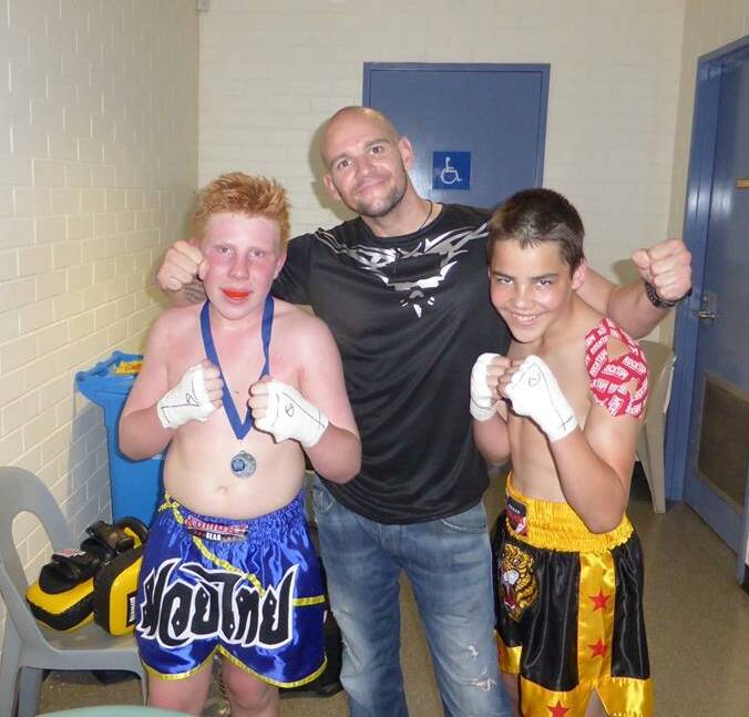 Hunter Buckley and Justin O'Halloran with their coach Waylon Prater at the state fight held in Mandurah. 