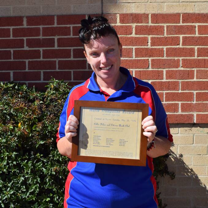 PCYC manager Amanda Dow holds the original trampoline world record certificate. 