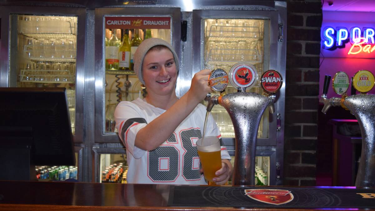 Back in action: Bar attendant Tahlia Gibbs pulls a pint. 