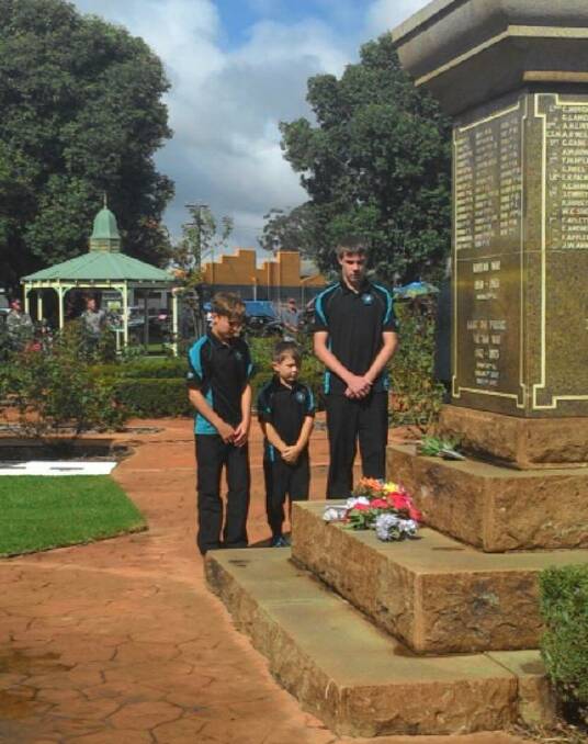 Respect: Junior Eagles members Riley Brown, Lucas Worlley and Michael Becker lay a wreath at the War Memorial on Anzac Day as part of the commemoration.