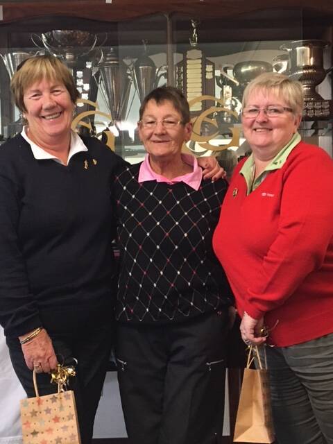 Winning duo: Nancy Lynn receiving her trophy from captain Dot Lawrence, along with her pairs partner Vicki Graham. Photo: supplied.