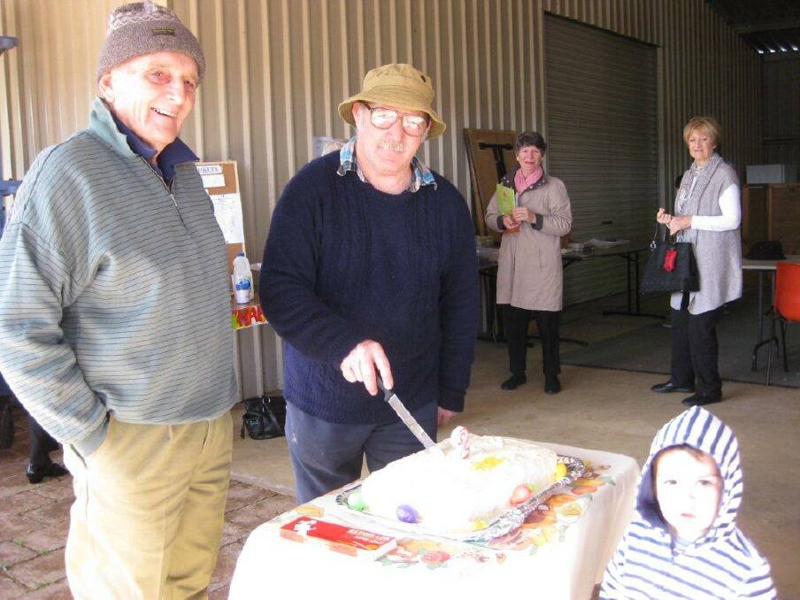 Happy birthday: Celebrating the Shed Markets second birthday are Dave South, Owen Harvey (cutting the cake), and Mitchell Gibbs.