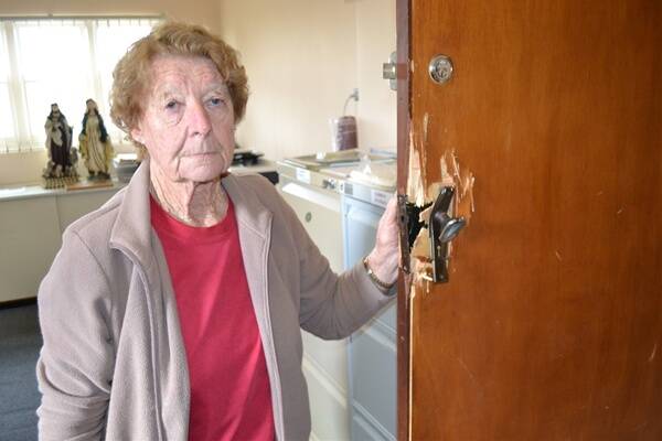 SADDENED: Collie Anglican Op Shop manager Margaret White beside the smashed office door.