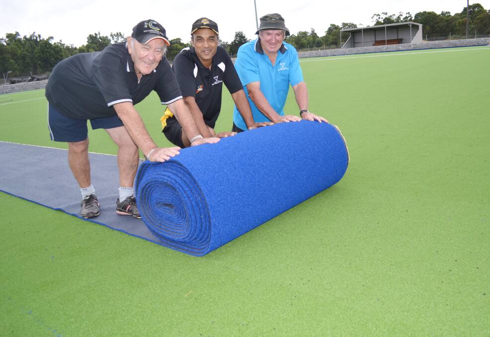 Roll out: Coalfields Hockey Council treasurer Taffy Davies, Collie Hockey Association president Gary Faries and council life member Collin Crowe roll out some of the new turf.