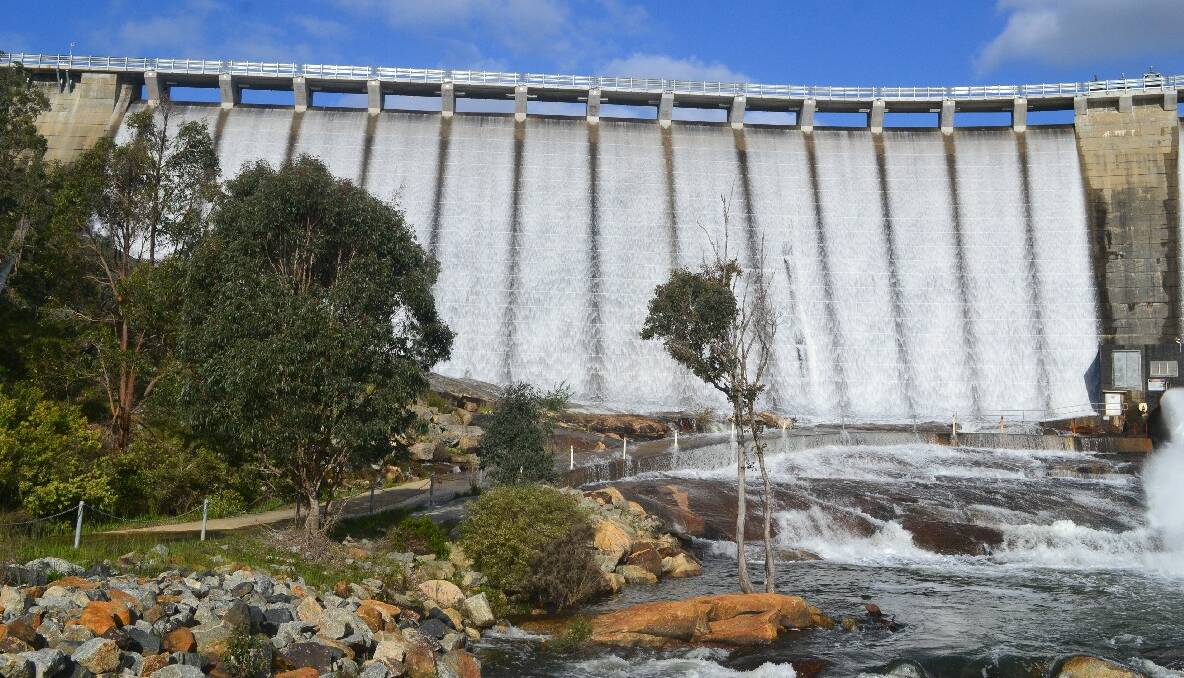 Waterworks: Wellington Dam begins to overflow for the first time since 2009, with parents and children flocking to see the amazing sight. Photos by Mackenzie Dixon.