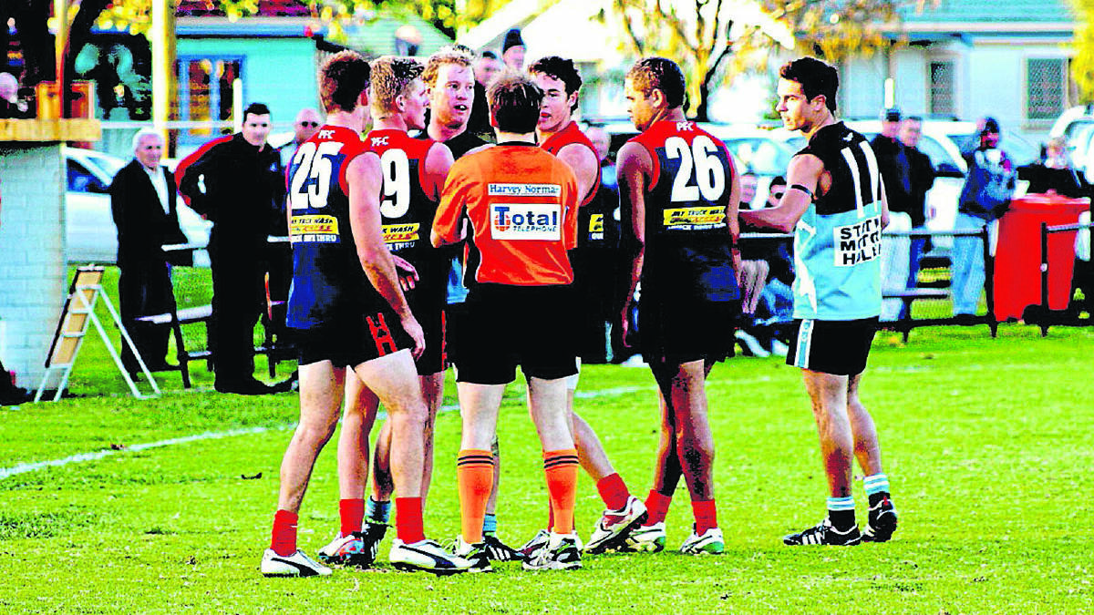 Tempers flare after the umpire awards a free kick. 
