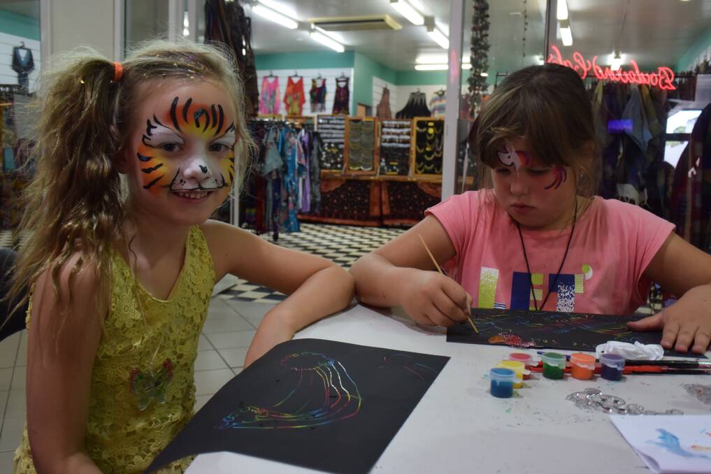 Working together: Riley and Kimbalee both developed bright, colorful works of art during the school holidays. 