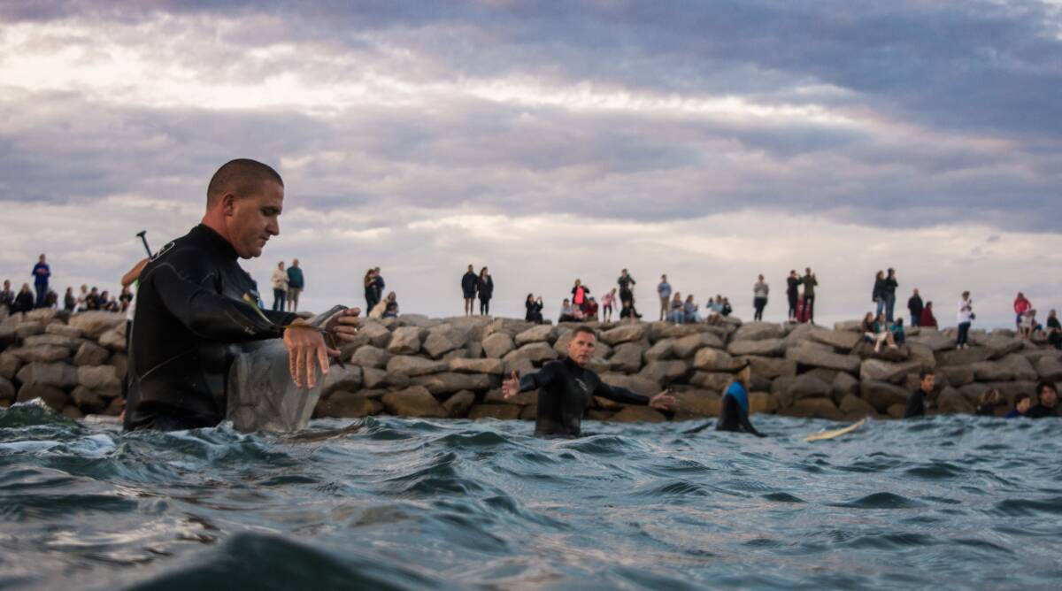 Tribute: Esperance man Chris Pope gets ready to join hands with fellow surfer Ross Tamlin, at a paddle-out in honour of shark attack victim Laeticia Brouwer. Mr Pope was at Wylie Bay when Laeticia was rushed by, headed for the Esperance Health Campus. Photo: Will Creed. 