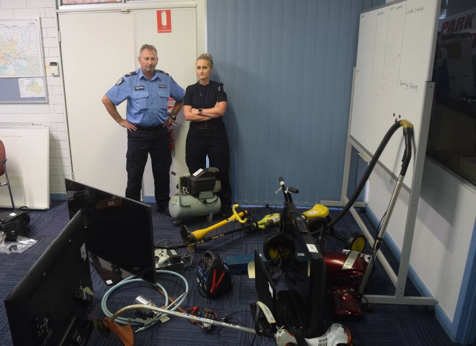 Senior Constable Jackson and Constable Ward with some of the recovered items. Photo: Ashley Bolt