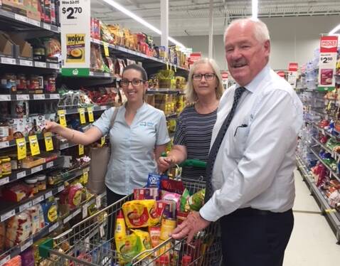 Unity Bank's Tenille Cherry, St Vinnies' Joanne Remeika and Collie-Preston MLA Mick Murray picking out items for Christmas hampers to help those in need.